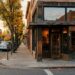 Brick corner building with a dark wooden storefront at dusk in downtown Walnut Creek